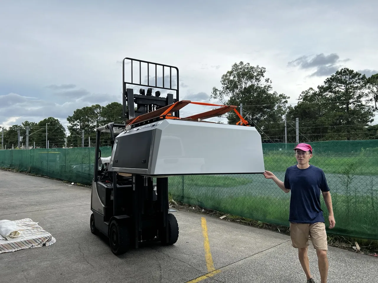 A canopy lifted by forklift outside a partner's warehouse